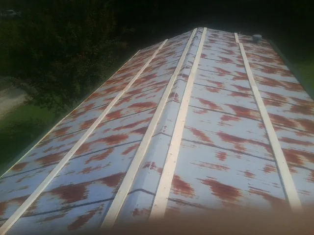 Rusted metal roof panels with new wood purlins before replacement — Storm Damage Roof Repair in South San Francisco by Roofing Brothers
