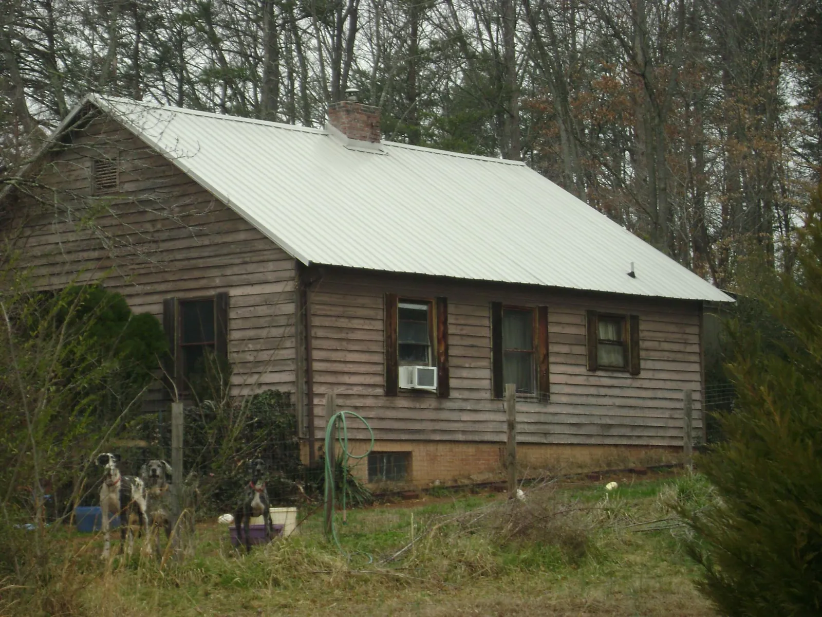 White metal roof on an old wood sided farmhouse, from a Asphalt Shingle Roof Repair job in South San Francisco